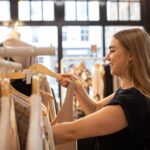 Sophie eCommerce Mentor checking outfits in a stall